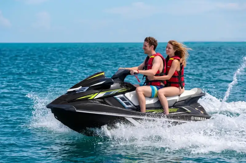 A certified dive buddy assisting underwater explorers with Dreamy Wave Dwelling Resort in the Semporna archipelago.